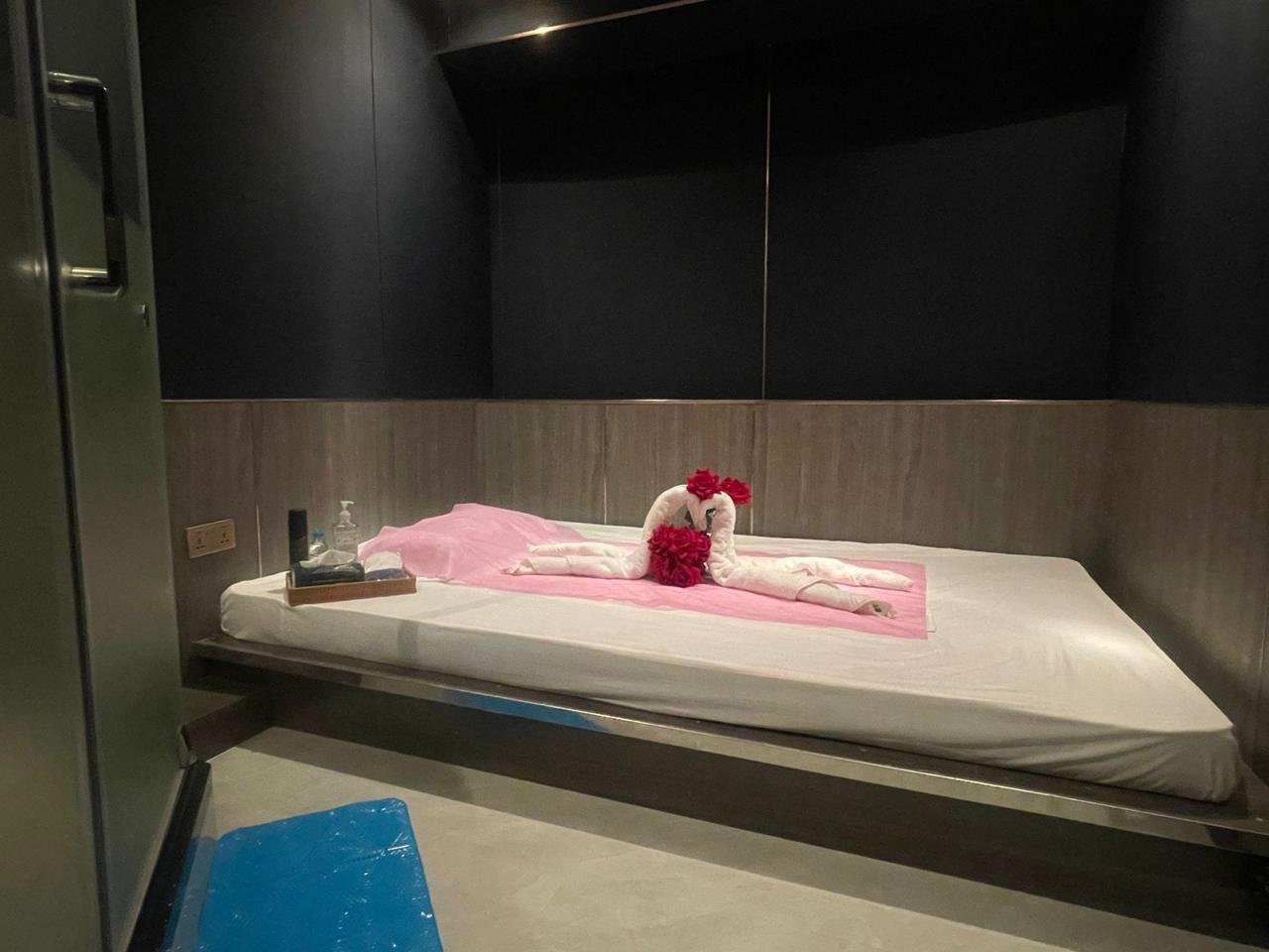 Private VIP treatment room with a rose-decorated towel display at Novara Thai Spa